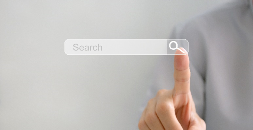 An image of a finger pointing to a search engine.