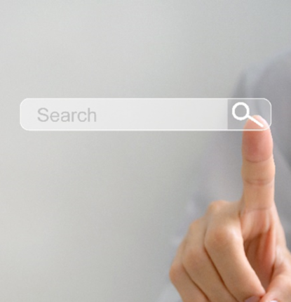 An image of a finger pointing to a search engine.