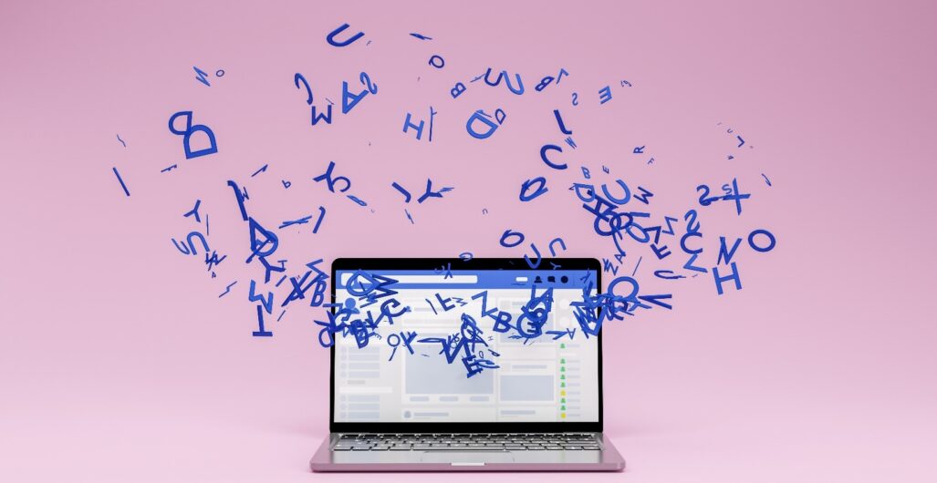 Laptop with a swirl of floating blue letters surrounding it.