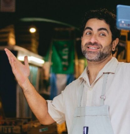 A business owner using his smartphone to record a video for Google Business Profile video verification.