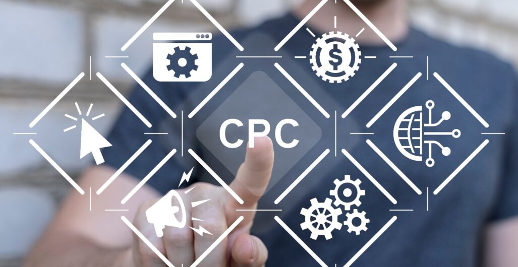 A hand with the pointer finger extended to touch the letters CPC in an icon surrounded by other icons about paid search.